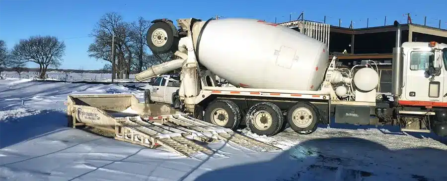 Concrete mixer dumping leftover into washout