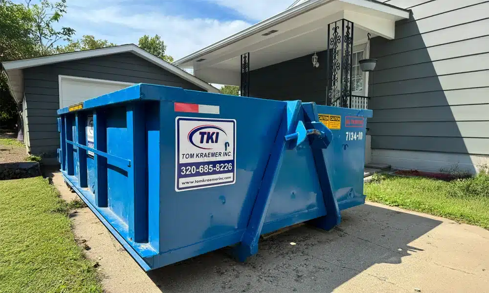 TKI Dumpster sitting next to house