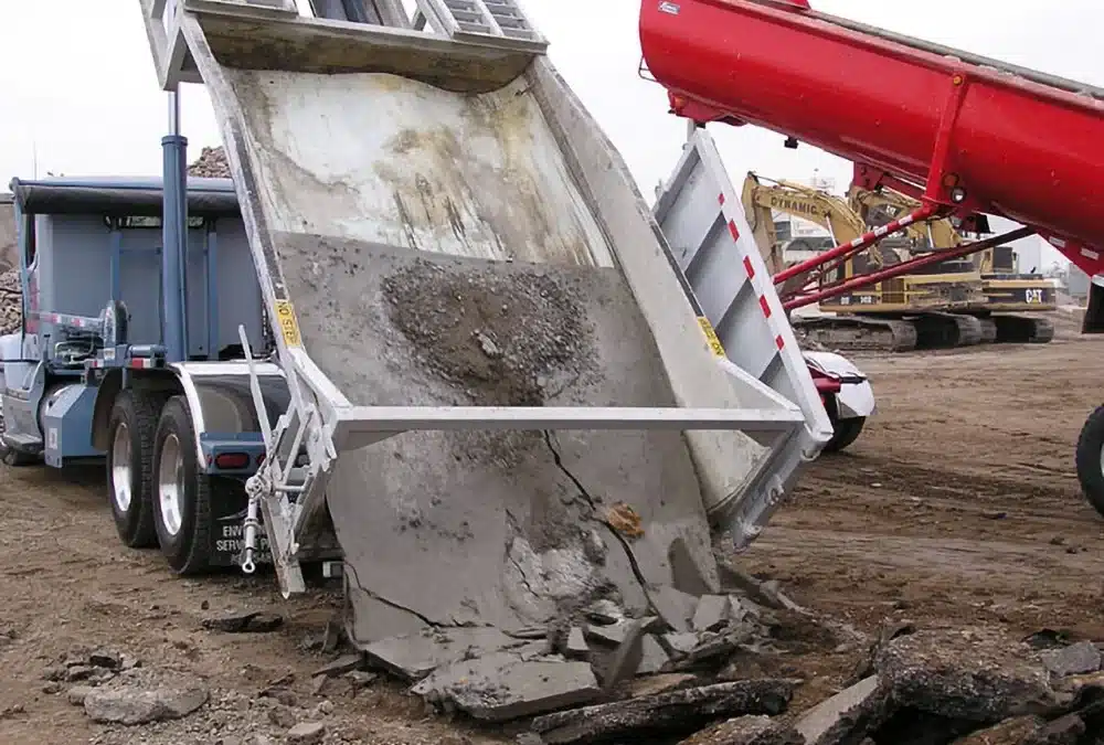 Dump truck unloading dried concrete